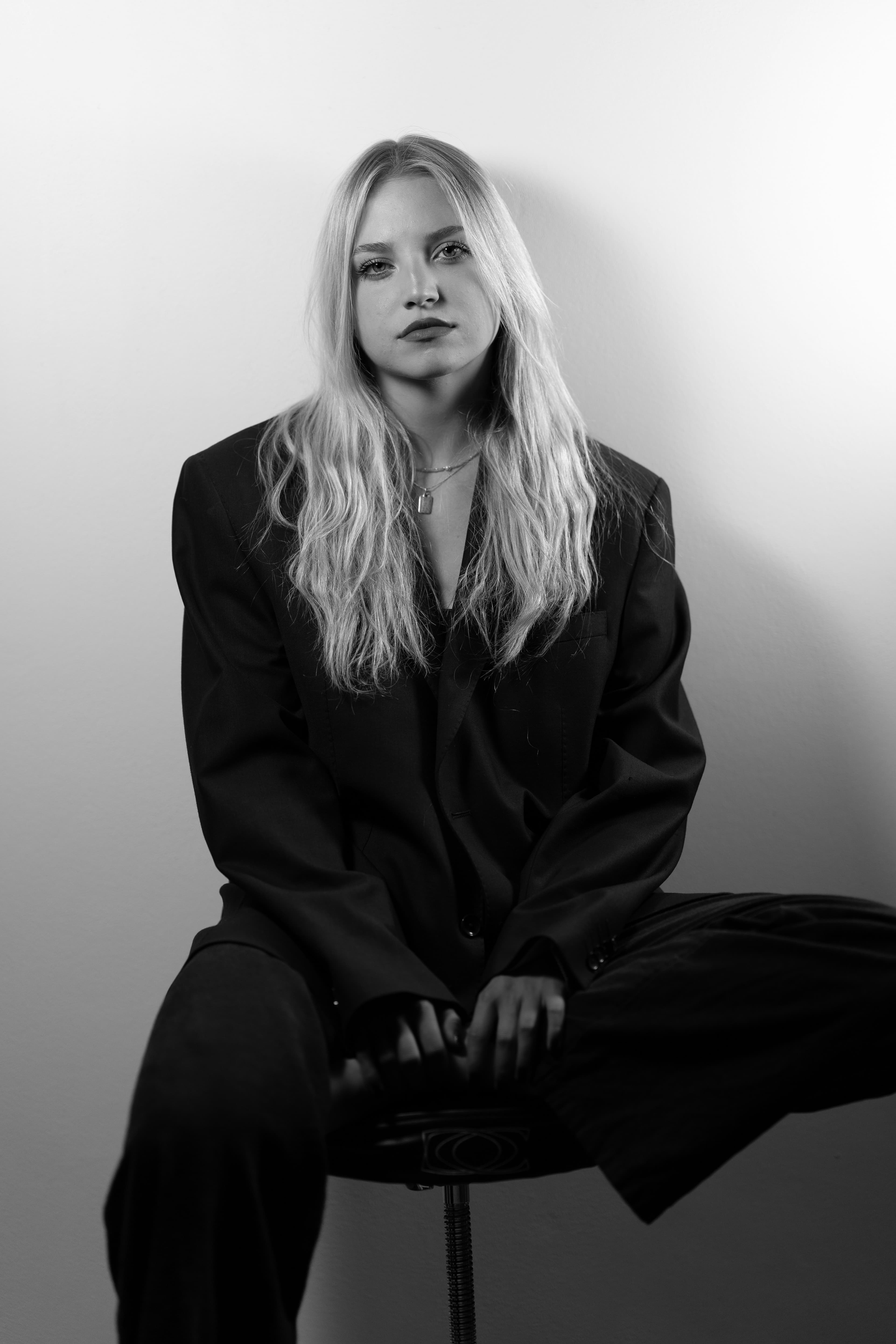 Black-and-white editorial fashion portrait with flash