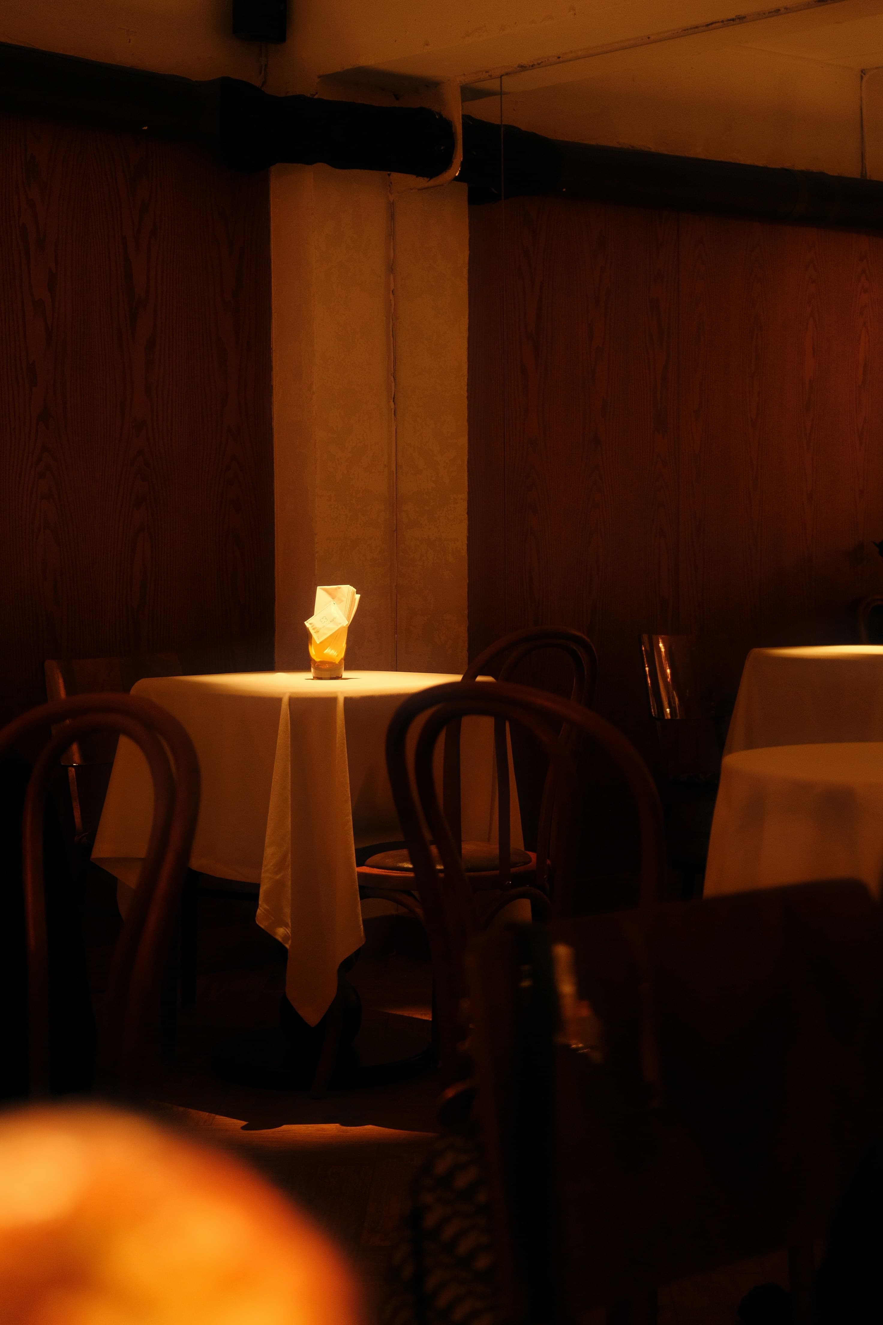 Glass of red wine beside a candle